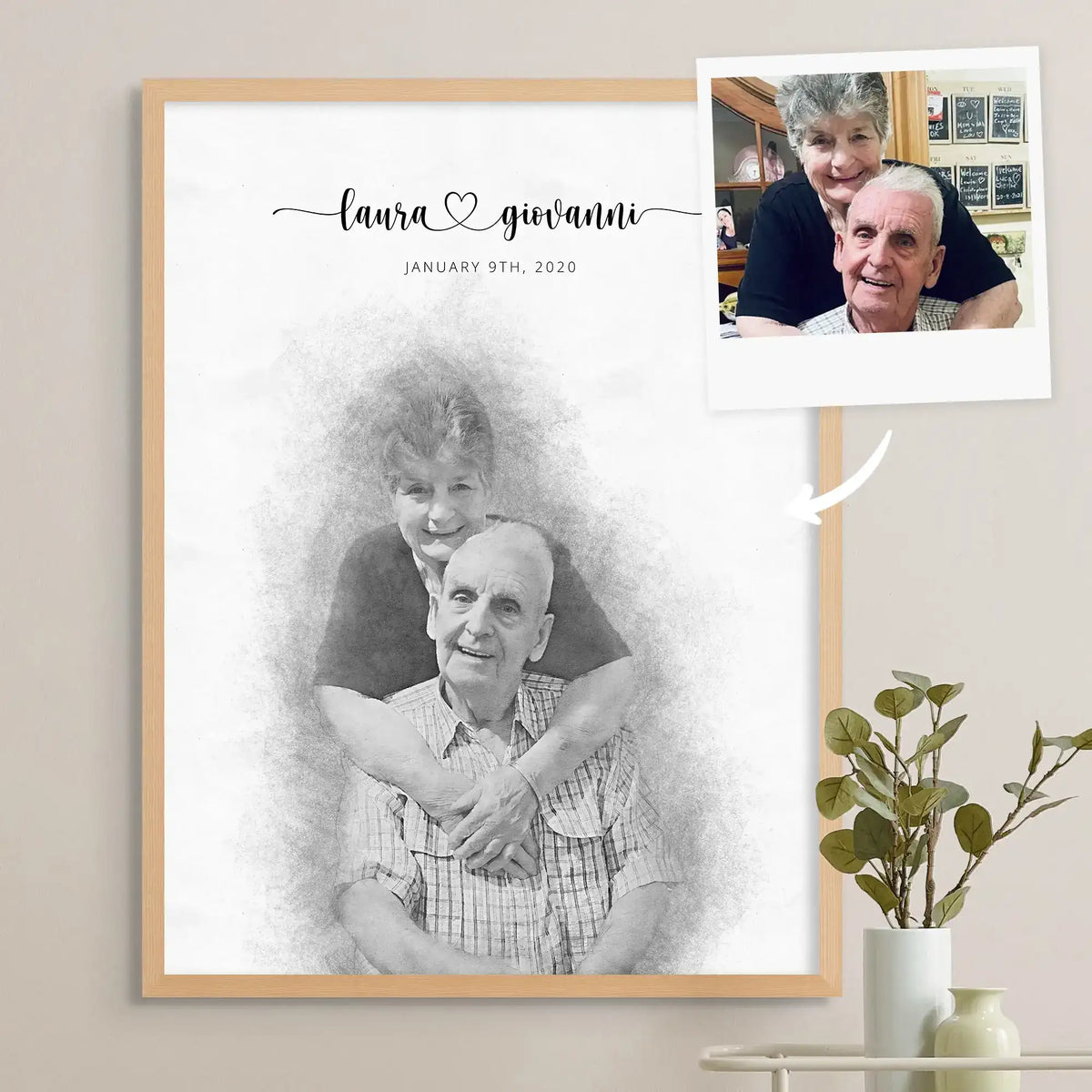 Sketch-style portrait of an older couple, the woman hugging the man from behind, in a light oak frame beside the source photo