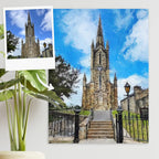 Oil-style canvas portrait of a stone church with a tall spire and steps, beside a small reference photo of the church