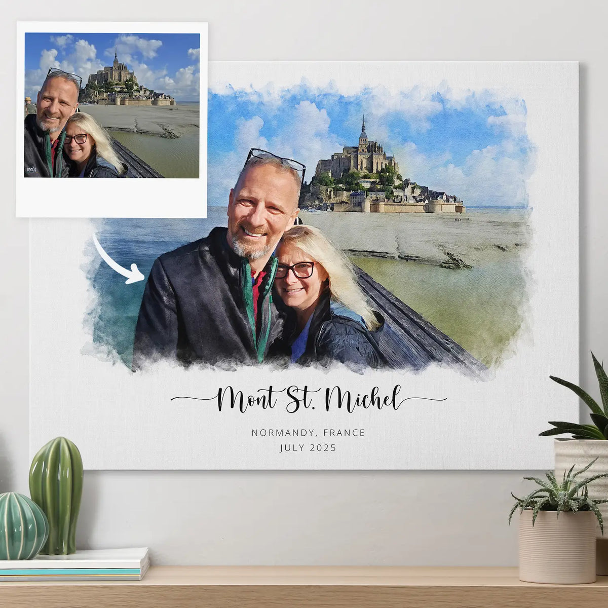 A man and woman smiling at Mont St. Michel in a snapshot, beside their watercolor-style portrait printed on canvas