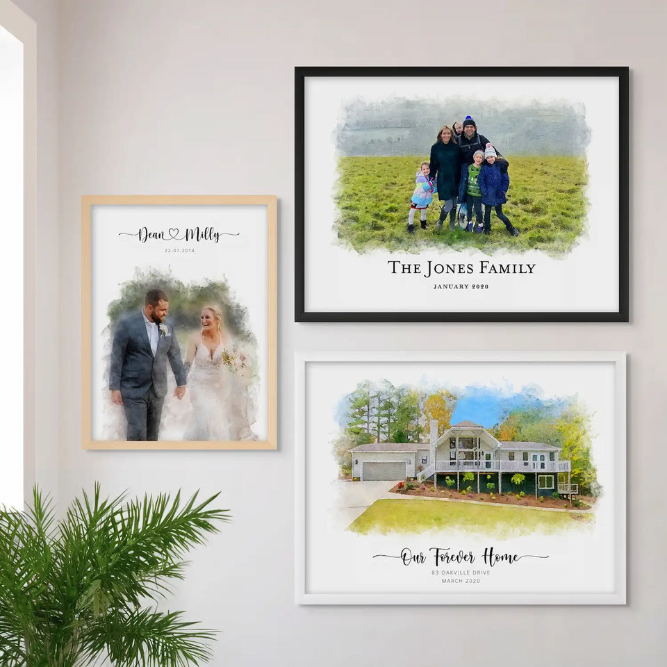 Three framed portraits on a white wall, of a wedding couple, a family in a field and a house, beside a green plant