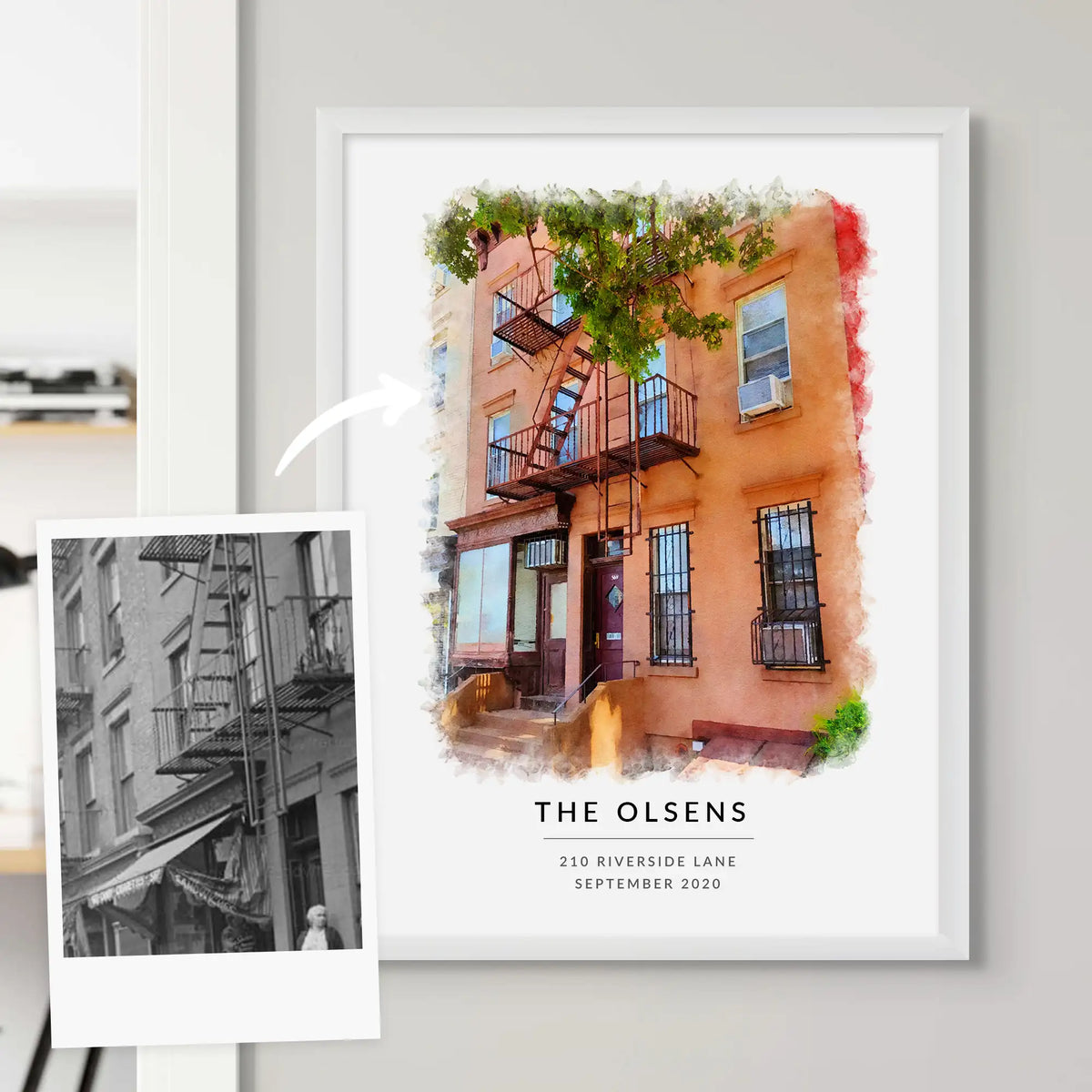 Watercolor-style portrait of an orange townhouse with a fire escape, framed in white, beside a black-and-white photo of it