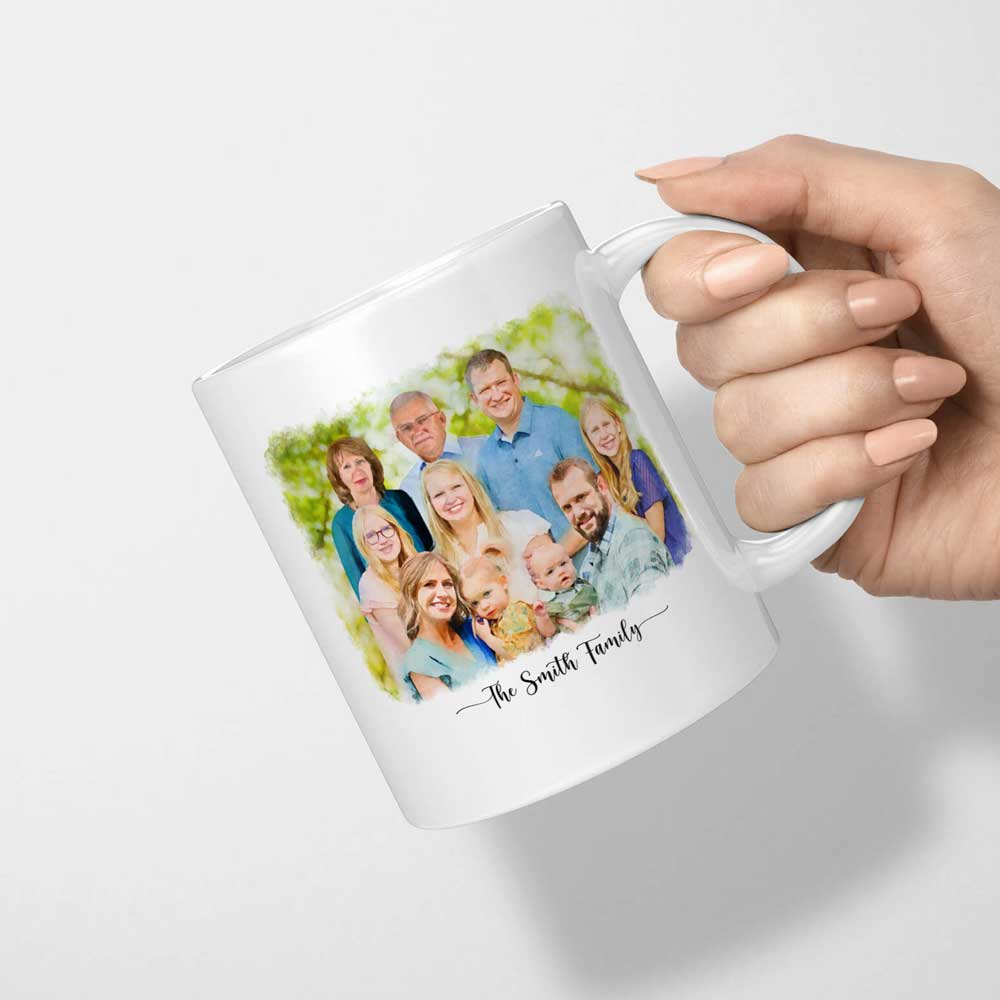 White mug printed with a watercolor-style portrait of a large family and 'The Smith Family', held by the handle